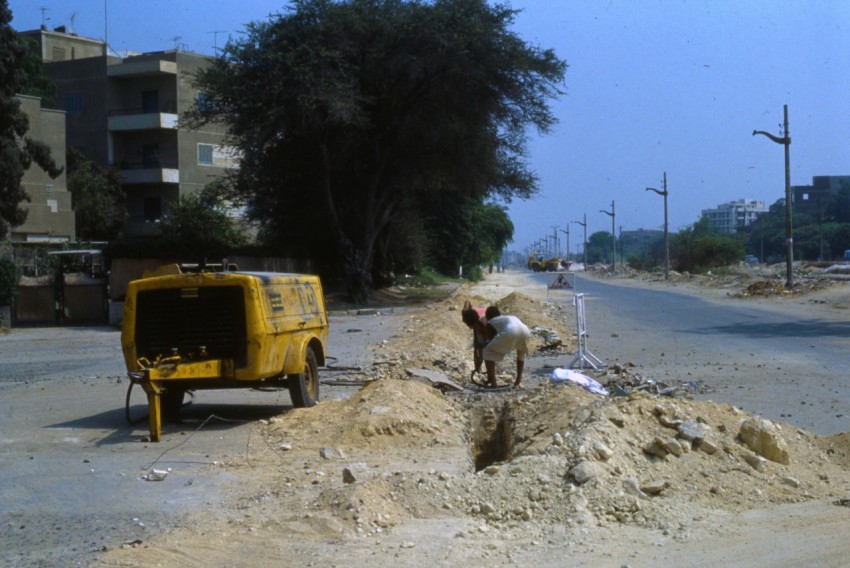 man in white shirt riding on yellow truck during daytime kd3cT