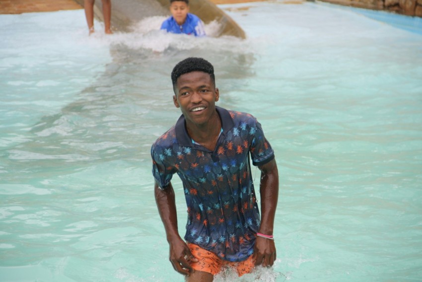 a man standing in the water at a water park