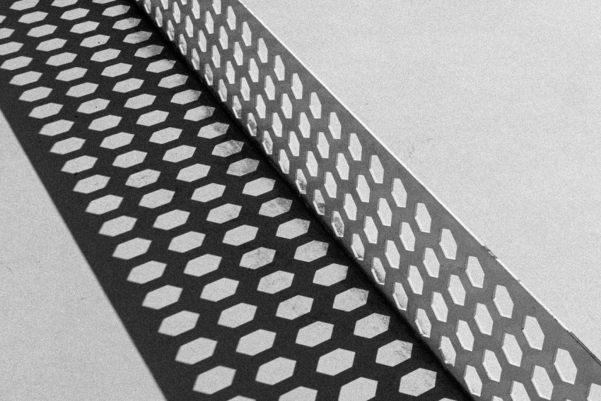 a black and white photo of a metal grate
