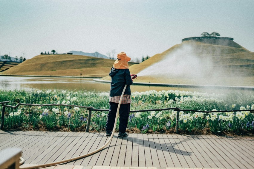 woman in black jacket standing on wooden dock during daytime K