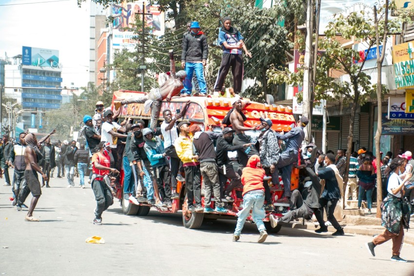 a group of people standing on top of a truck UU