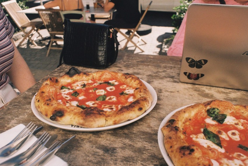 a couple of pizzas sitting on top of a table