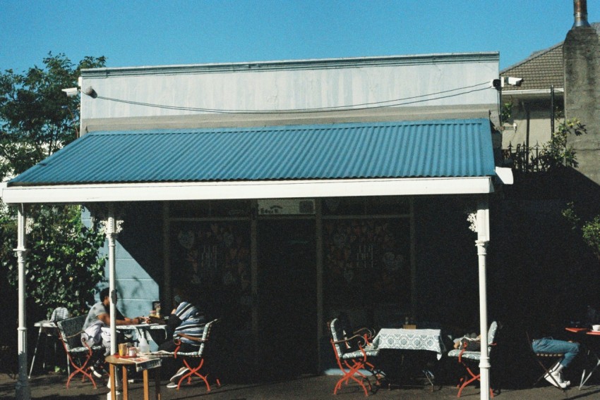 a group of people sitting at a table outside of a building