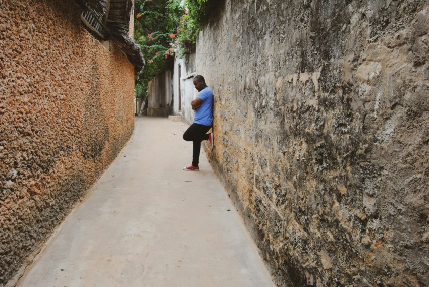 woman in white long sleeve shirt and black skirt walking on gray concrete pathway during daytime