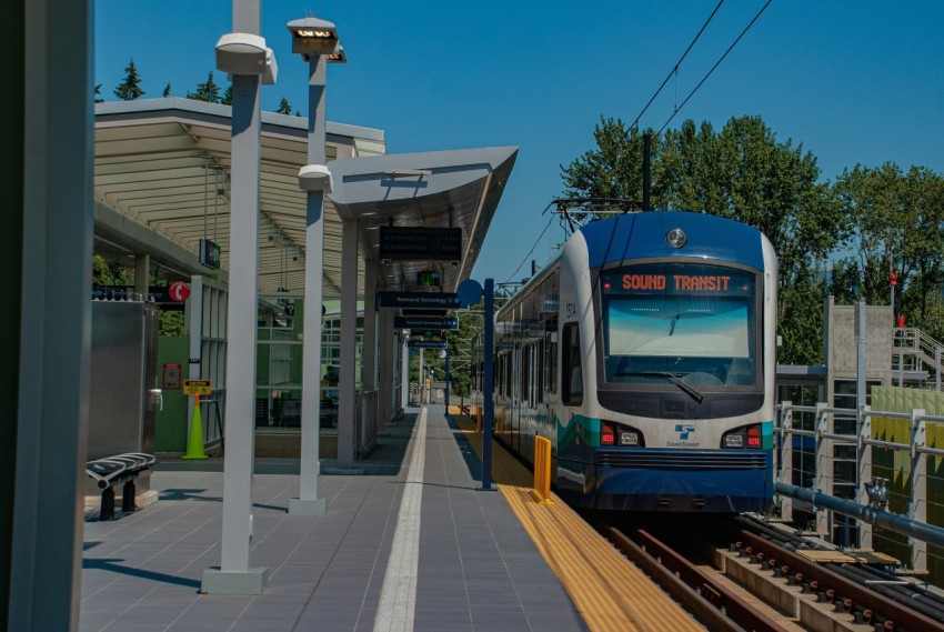 a blue and white train pulling into a train station