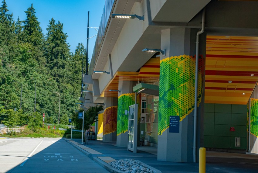 a row of storefronts with trees in the background