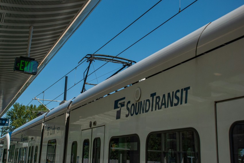 a white train stopped at a train station