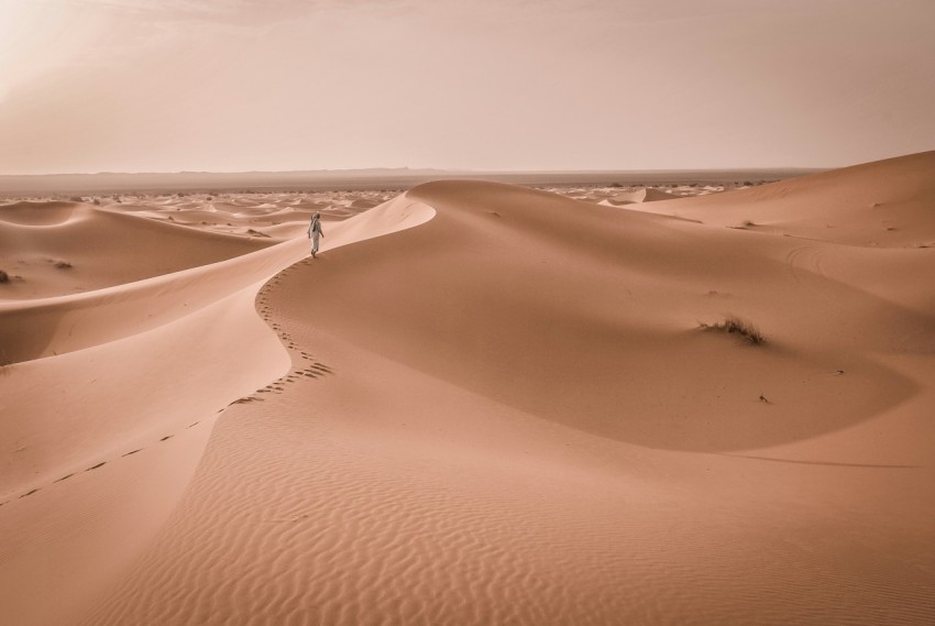 person walking on desert