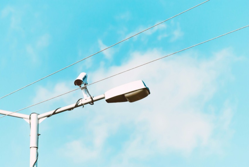 closeup photo of white lamp post and camera