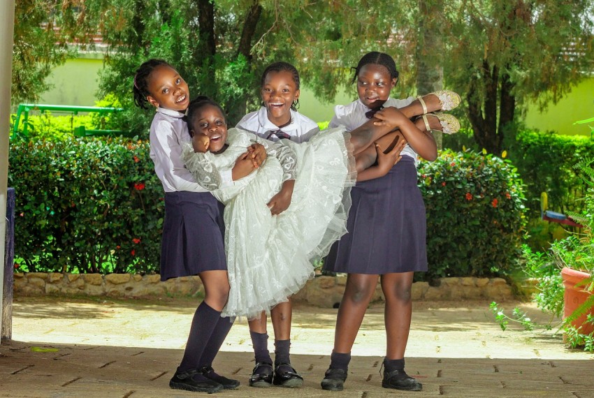 a group of young girls standing next to each other