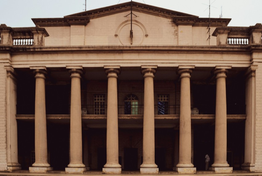 a large building with columns and a clock tower uc3l