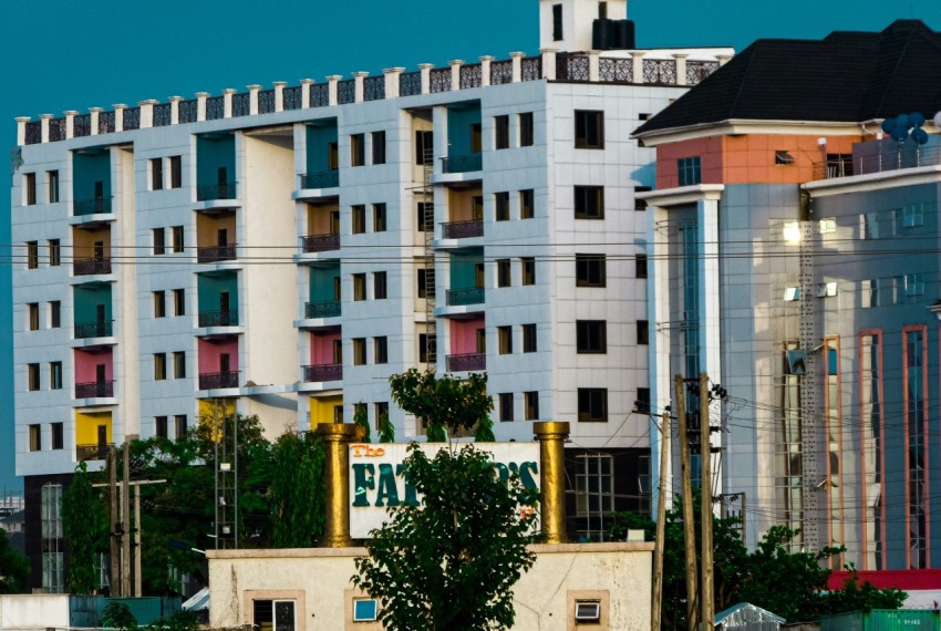 a tall white building with a clock on the top of it