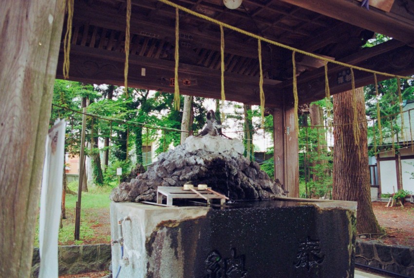 a wooden structure with a rope hanging from it