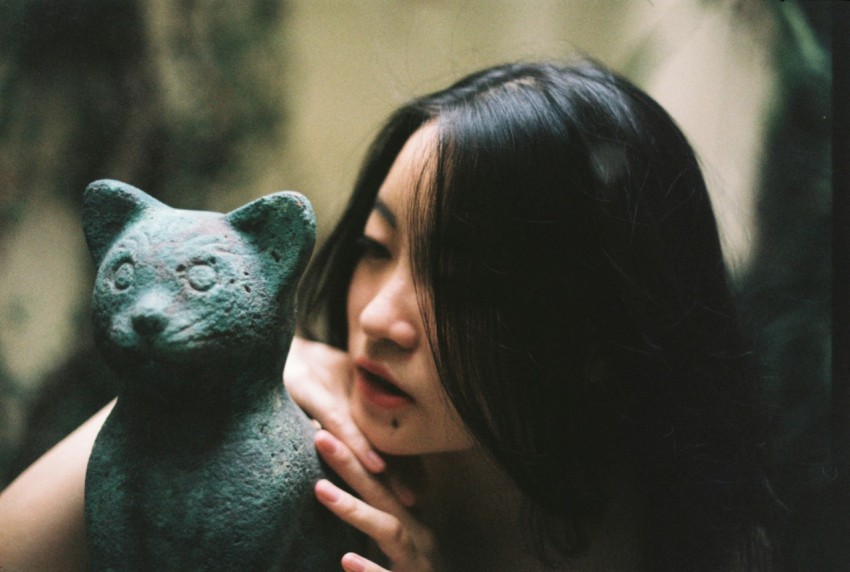 woman holding black and white animal figurine