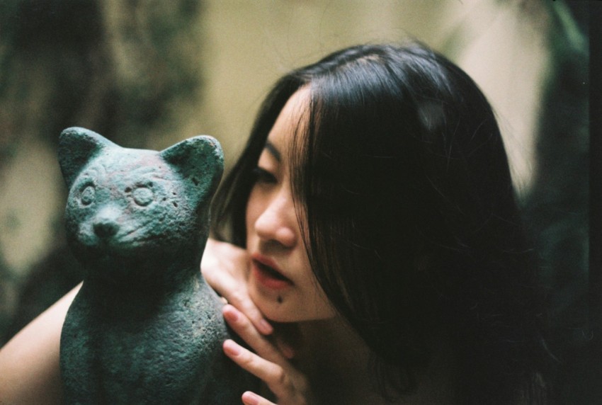 woman holding black and white animal figurine
