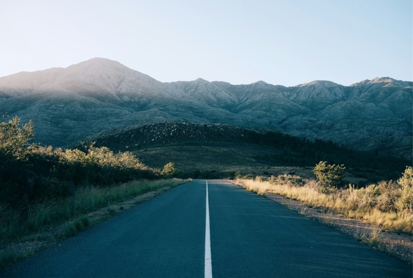 concrete road leading to the mountains