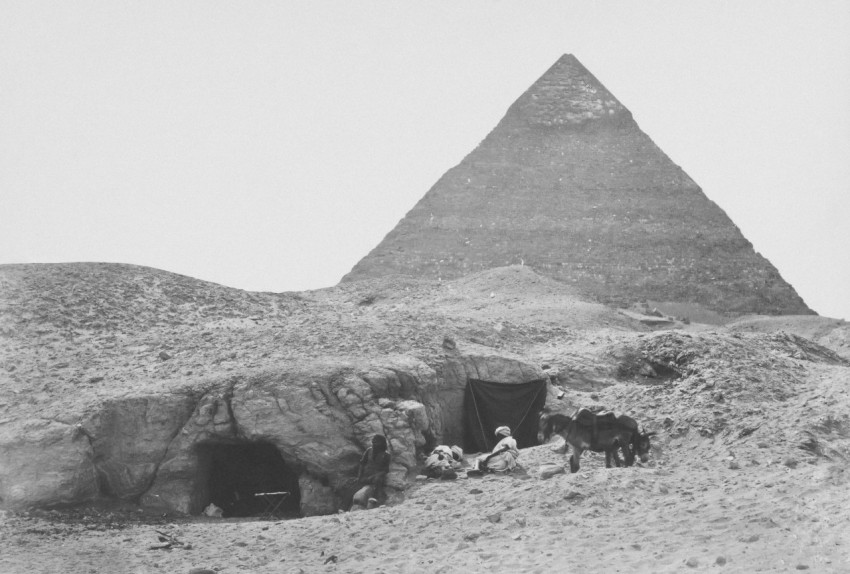 a group of people standing in front of a pyramid