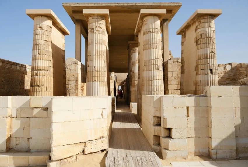 a group of pillars in a building with a sky background 4