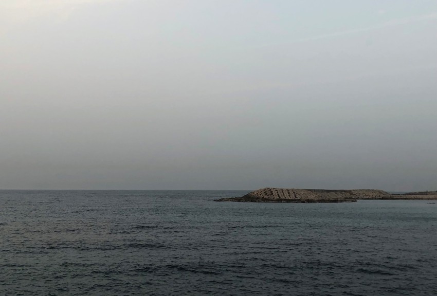 a large body of water sitting under a cloudy sky