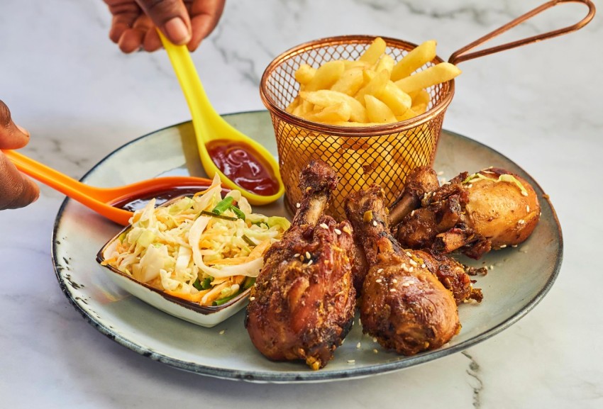 a plate of food that includes chicken potatoes and coleslaw