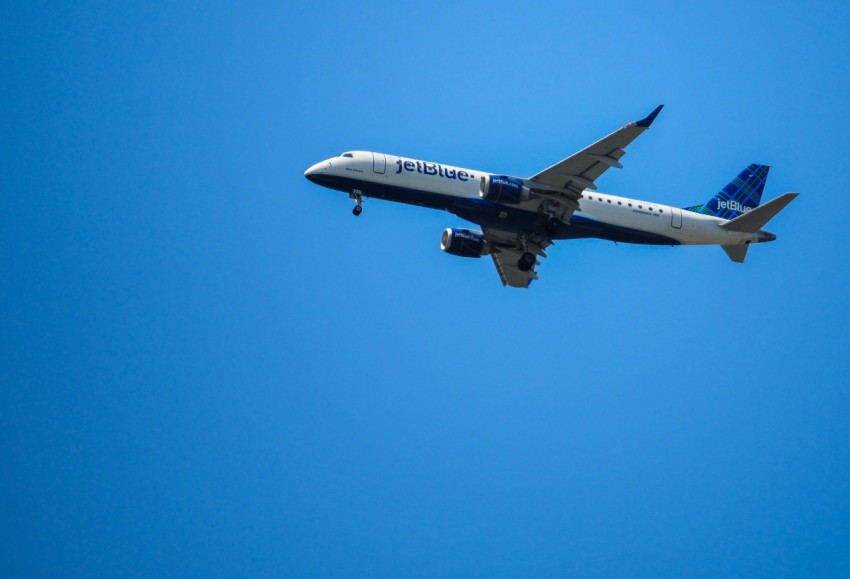 a large jetliner flying through a blue sky