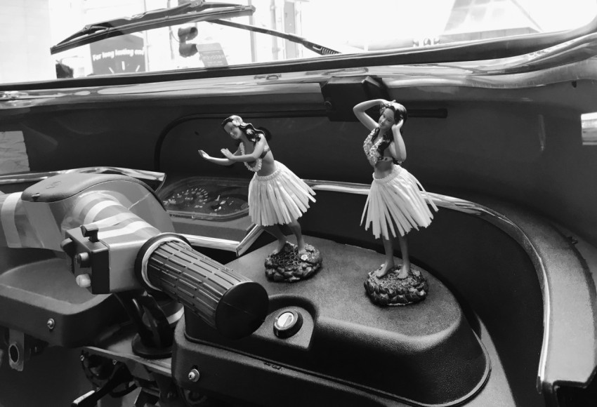 grayscale photo of woman in dress sitting on car seat aQonL