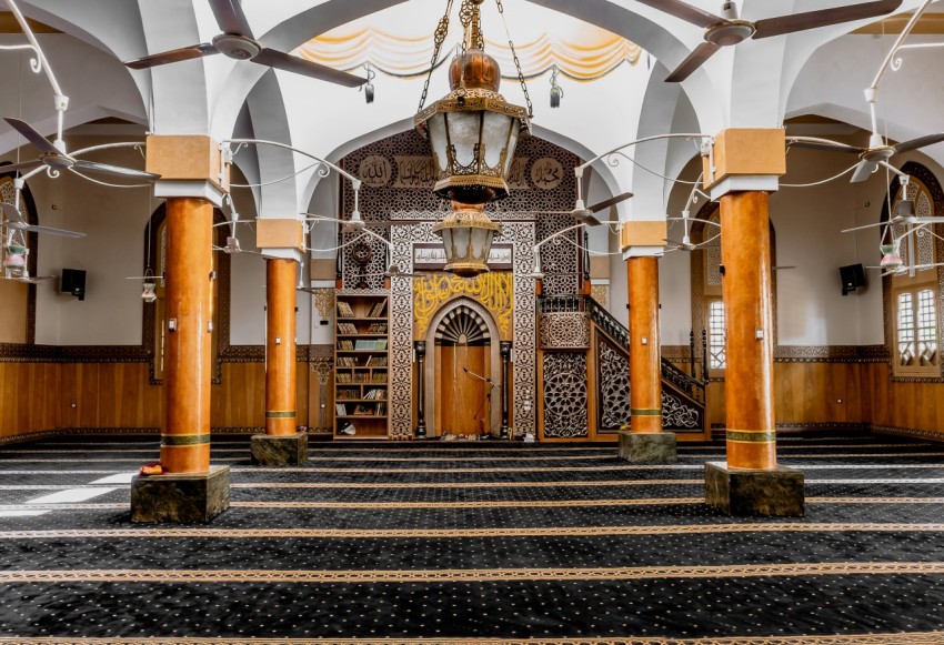 a large room with columns and a chandelier