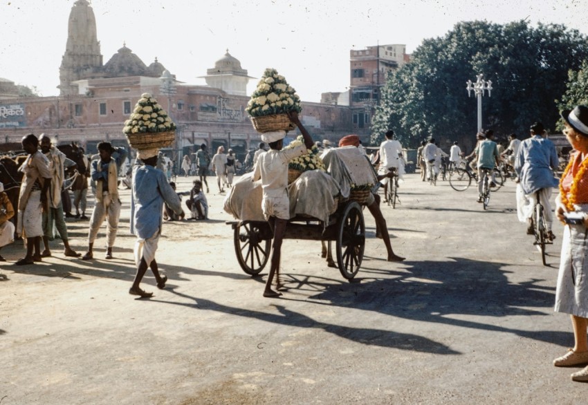 a group of people riding on the back of a horse drawn carriage