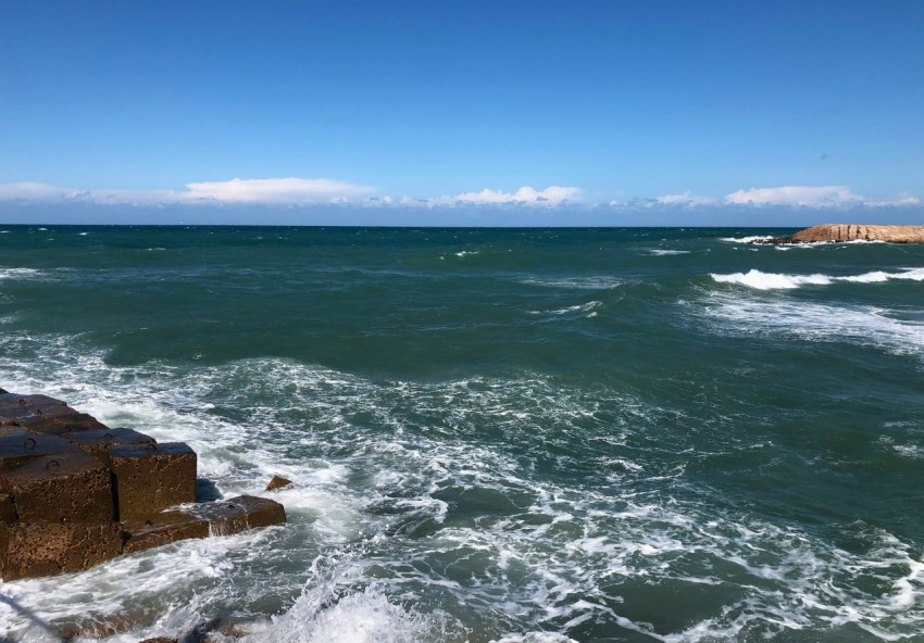 a view of a body of water with rocks in the foreground 0QOvz