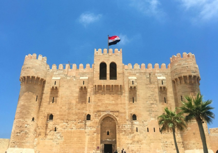 a large castle with a flag on top of it