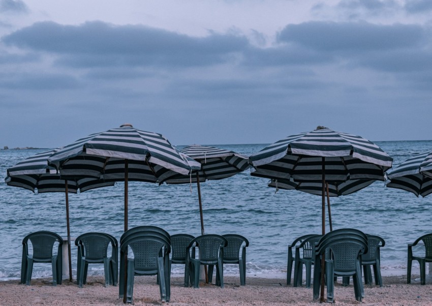 a group of chairs and umbrellas on a beach