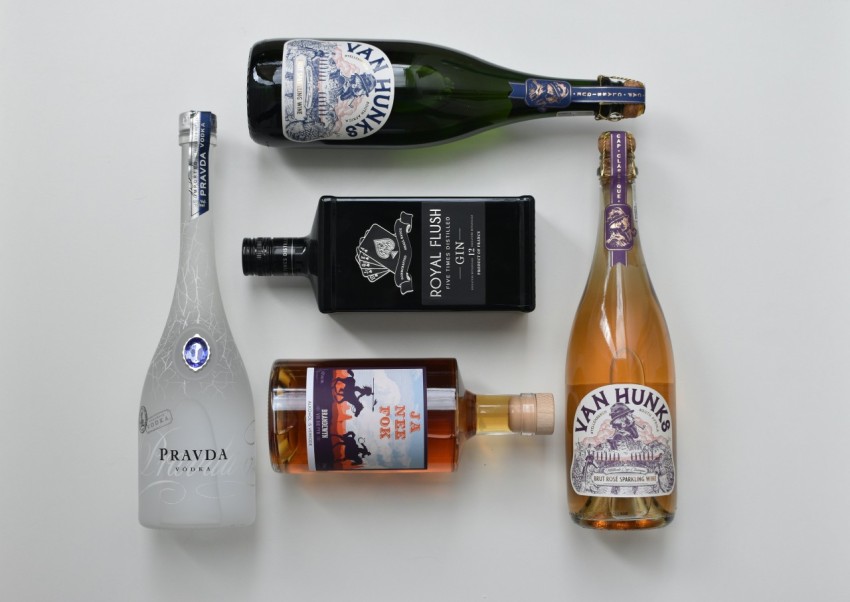 a variety of alcohol bottles and a bottle of wine