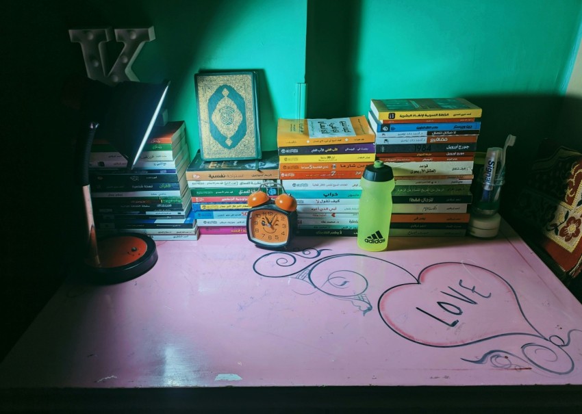 a table topped with lots of books and writing