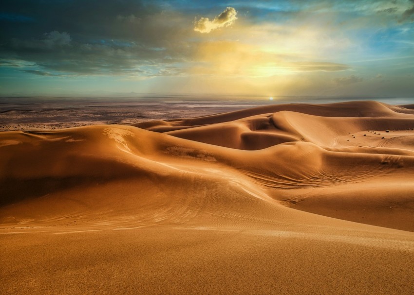 brown sand under cloudy sky during daytime