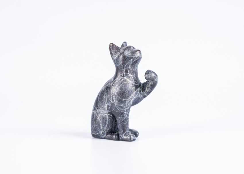 a small statue of a bear on a white background