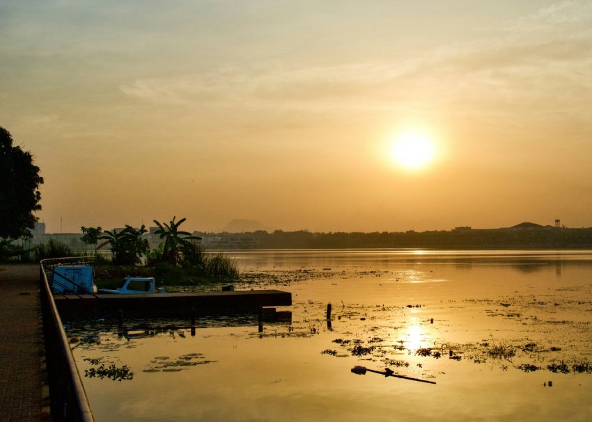 the sun is setting over a body of water