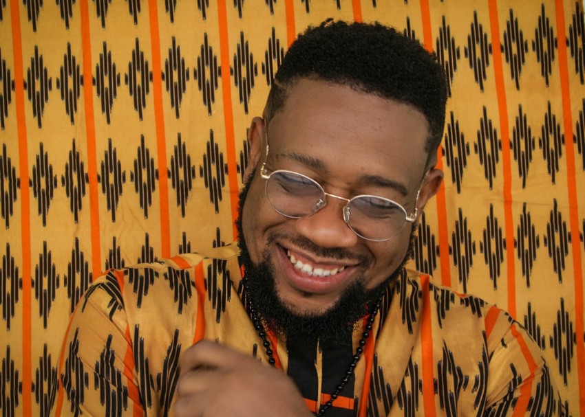 a man with a beard and glasses smiling