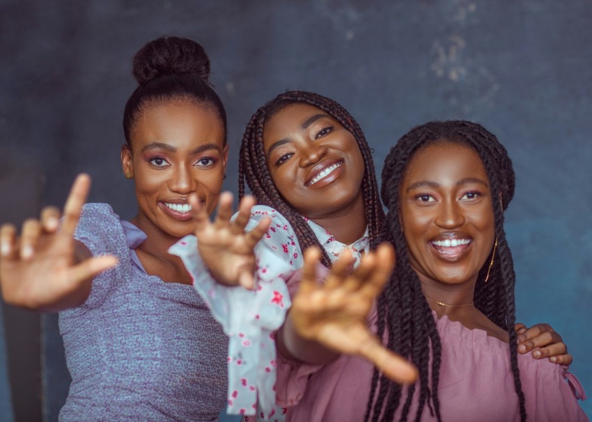 a group of three women standing next to each other DVGB2C