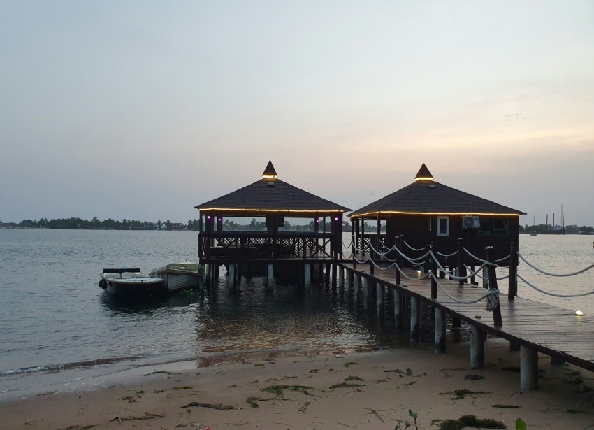 a pier with two small huts on top of it