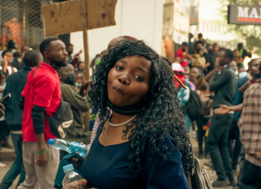 a woman standing in front of a crowd of people