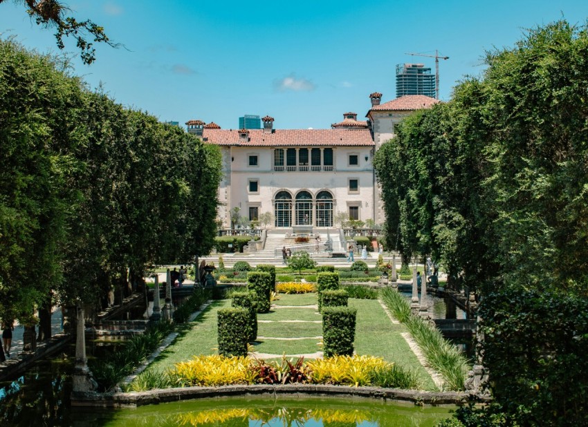 a large building with a pond in front of it