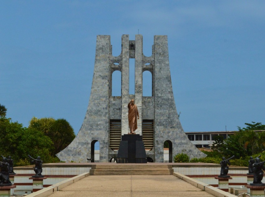 a statue of a person standing in front of a building