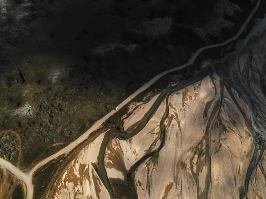 an aerial view of a mountain with a river running through it