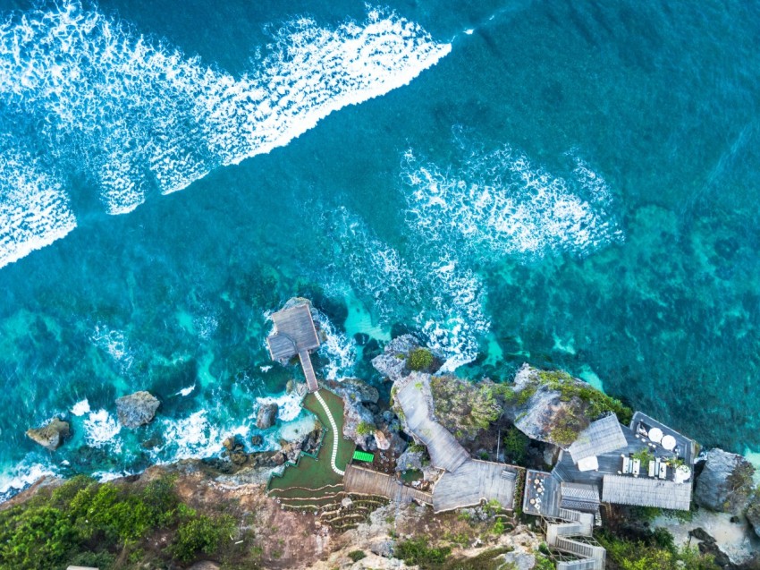 aerial photo of villa near body of water during daytime