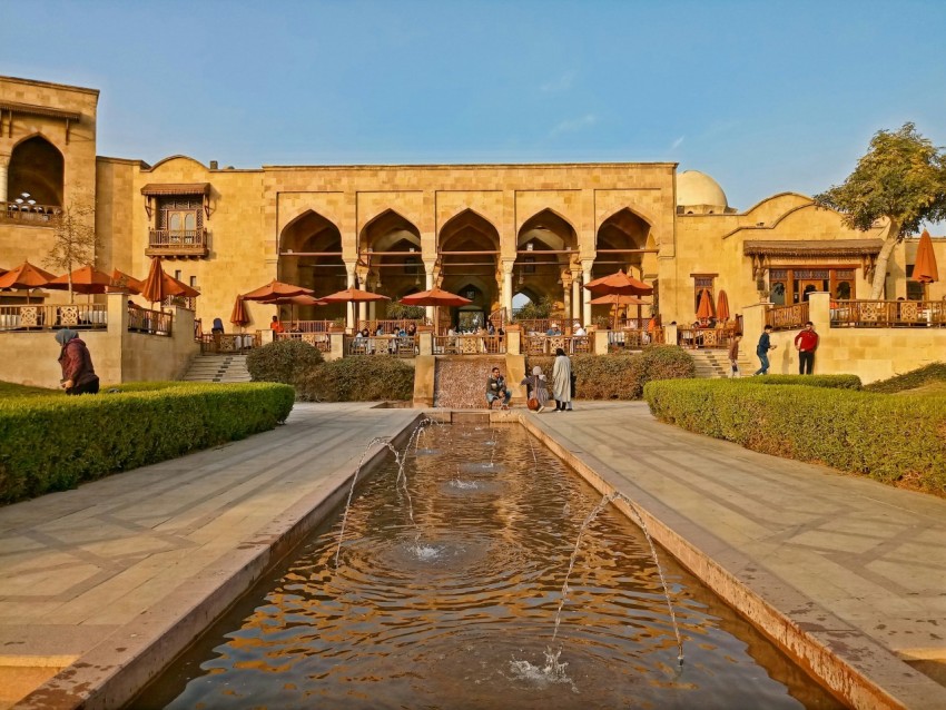 a large building with a fountain in front of it