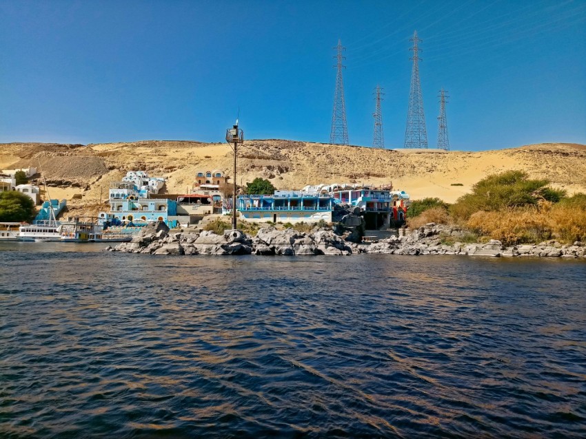 a group of boats sit on a rocky shore