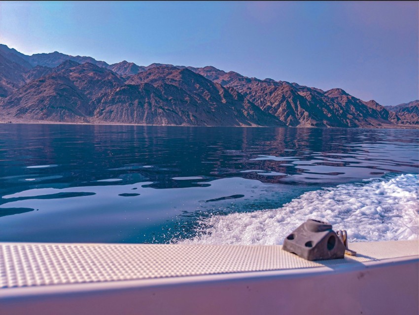 a body of water with mountains in the background