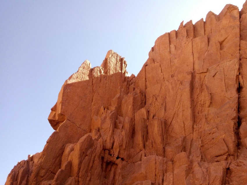 a large rock formation with a sky background