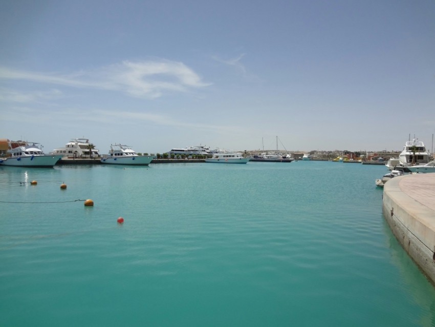 white boat on sea under blue sky during daytime r