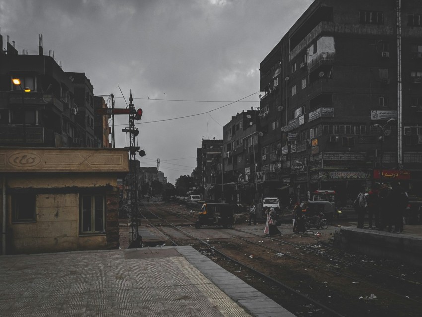 cars on road between buildings during daytime